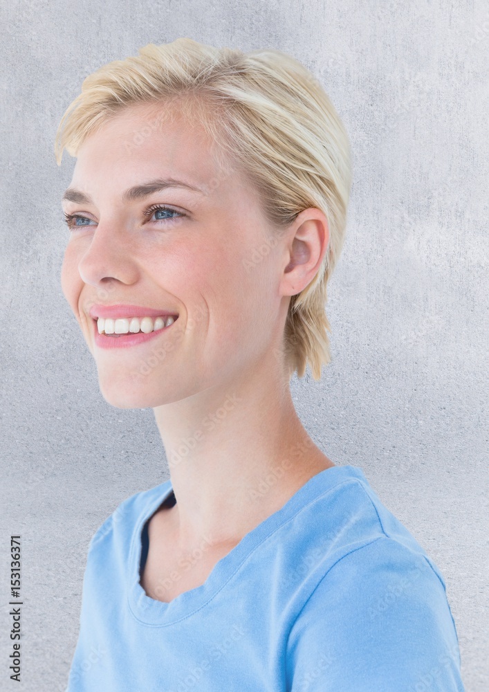 Close up portrait of woman against grey wall