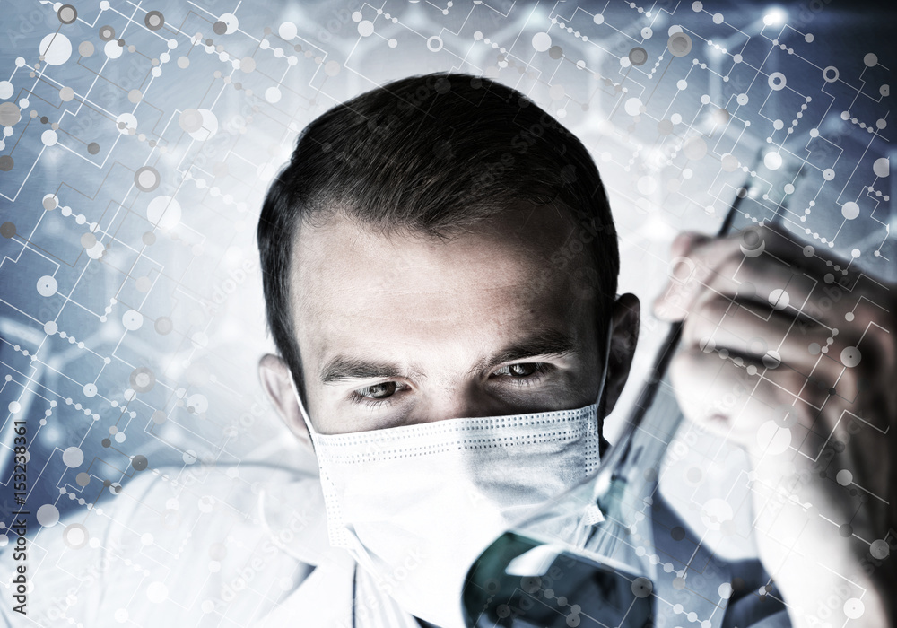 Portrait of concentrated male scientist working with reagents in laboratory