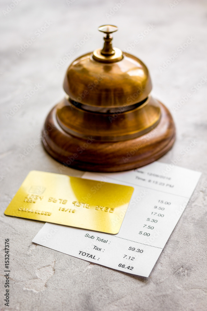 paying check for lunch in cafe with credit card on stone table background