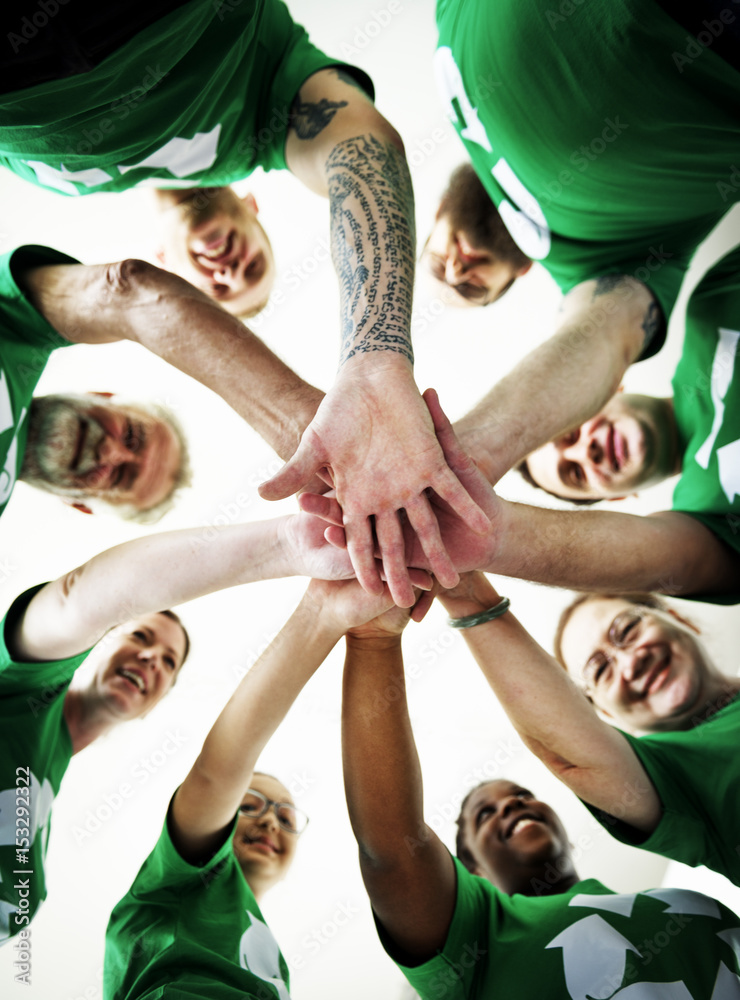 People joining hands together and smiling