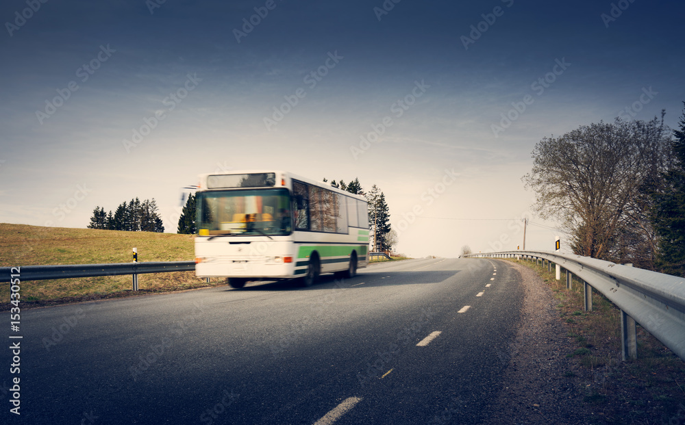 Bus on asphalt road in beautiful spring day at countryside