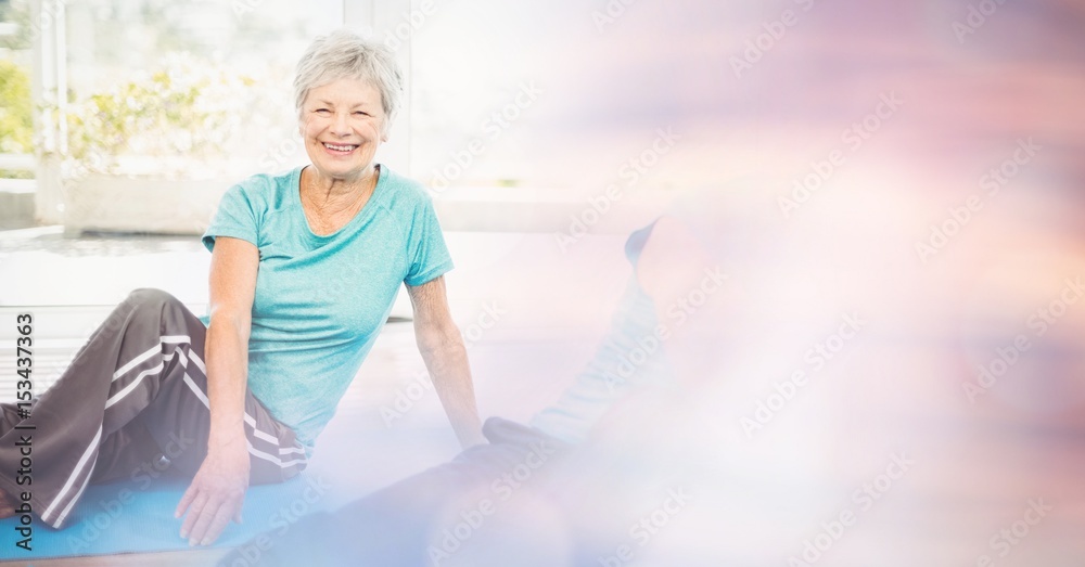 Fit senior woman exercising in yoga class