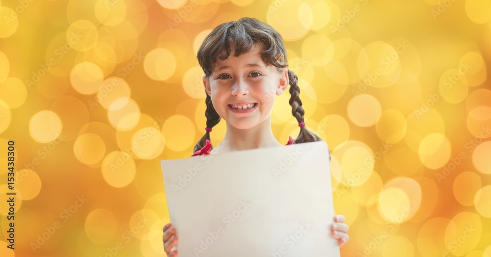 Happy girl holding placard over defocused background