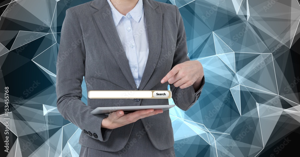 Midsection of businesswoman pointing at screen over digital tablet