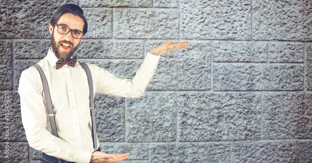 Hipster gesturing against wall