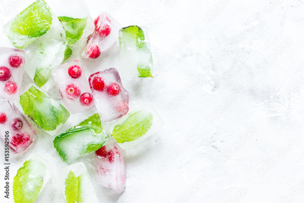 fresh cranberry in ice cubes on gray stone background top view mock-up