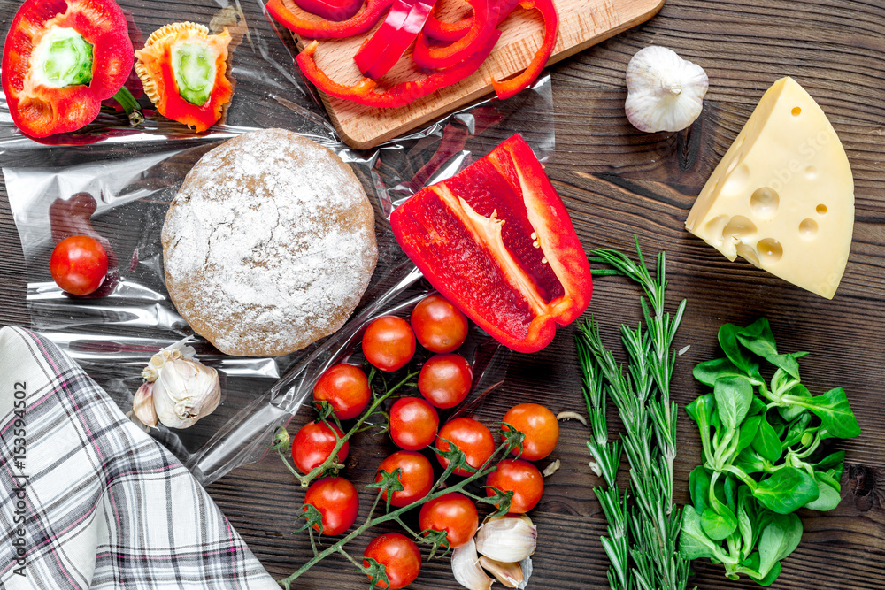 vegetables and cheese for cooking pizza on wooden table background top view