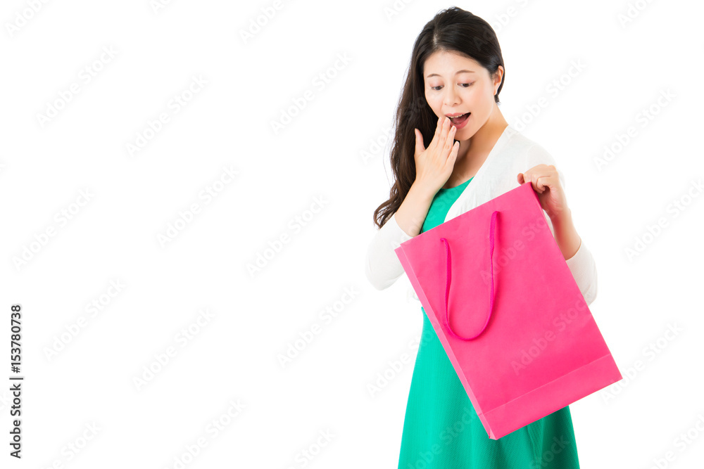 surprised woman looking pink shopping bag