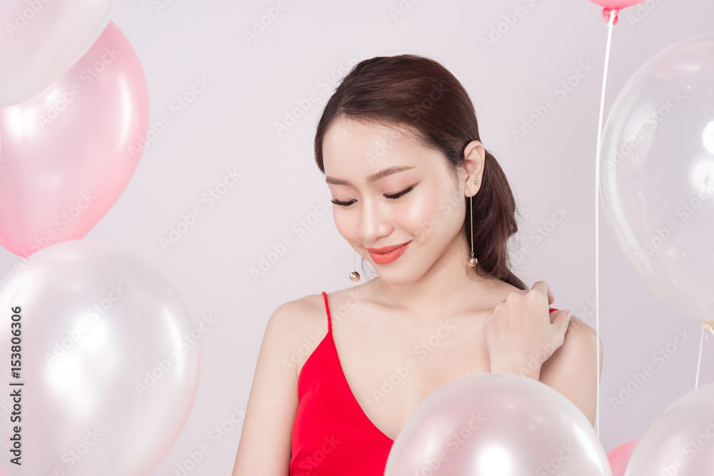 Asian beautiful woman in red dress with pastel balloons