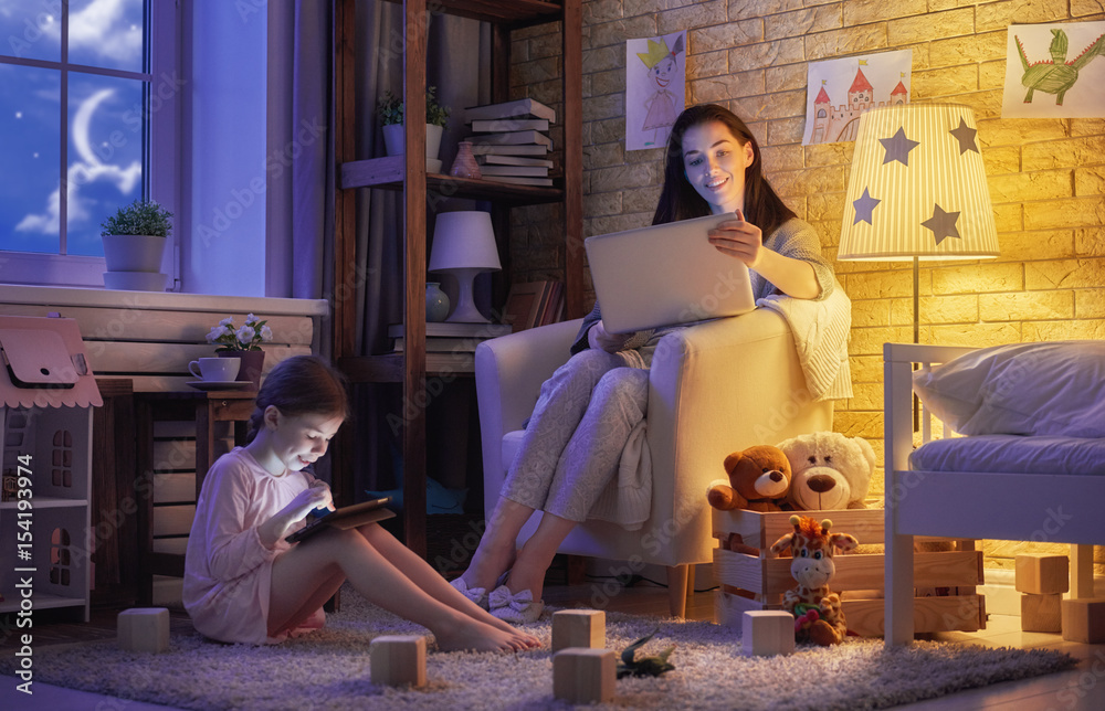 mother and her daughter with laptop