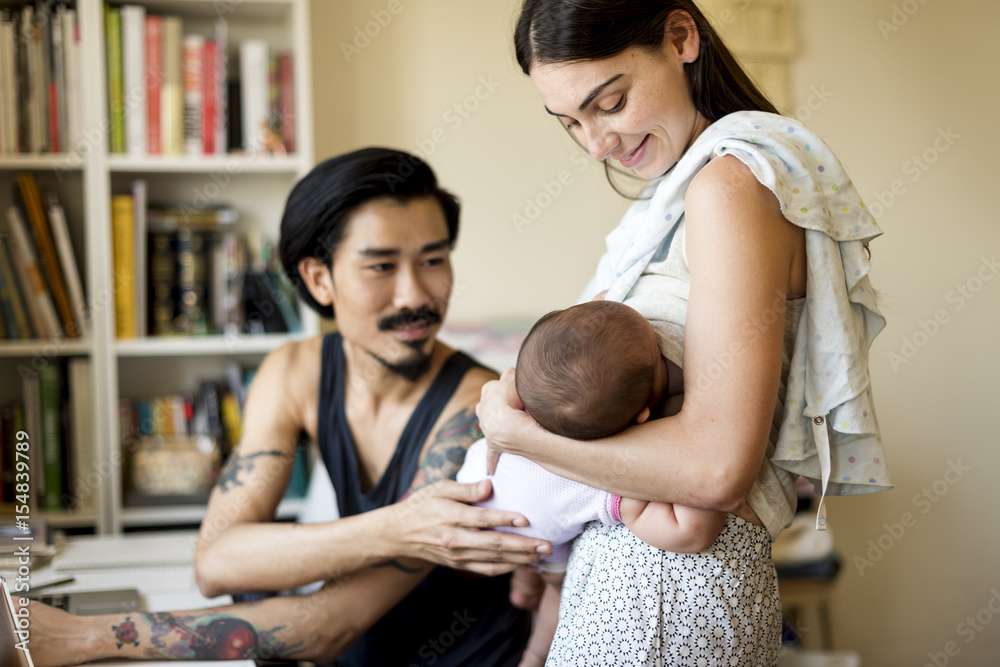 Father and mother are taking care of their child.