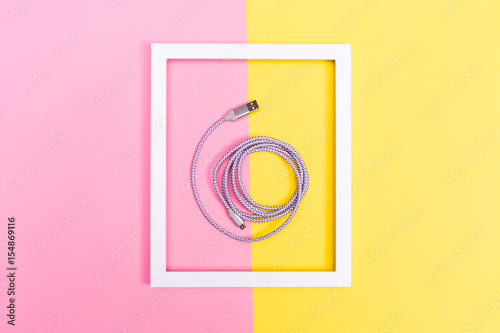 USB cable and frame on split background