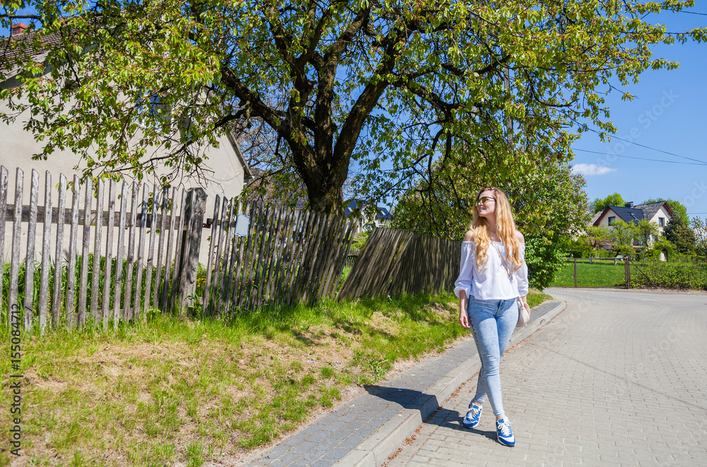 Girl walking on street during summer vacation in the countryside