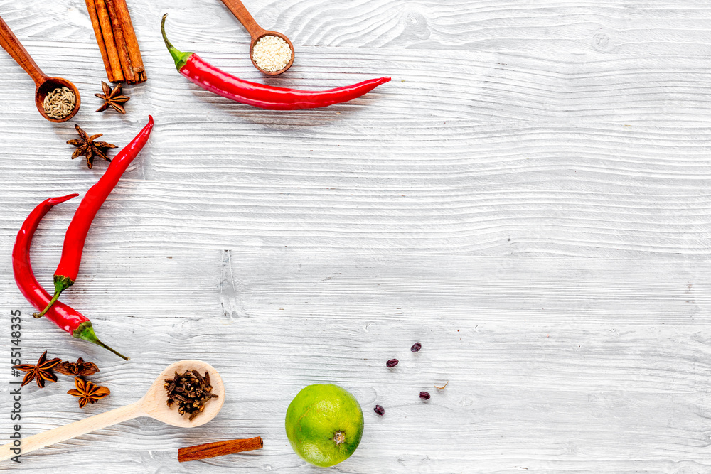 Spices, chili and herbs on wooden kitchen table background top view mock up