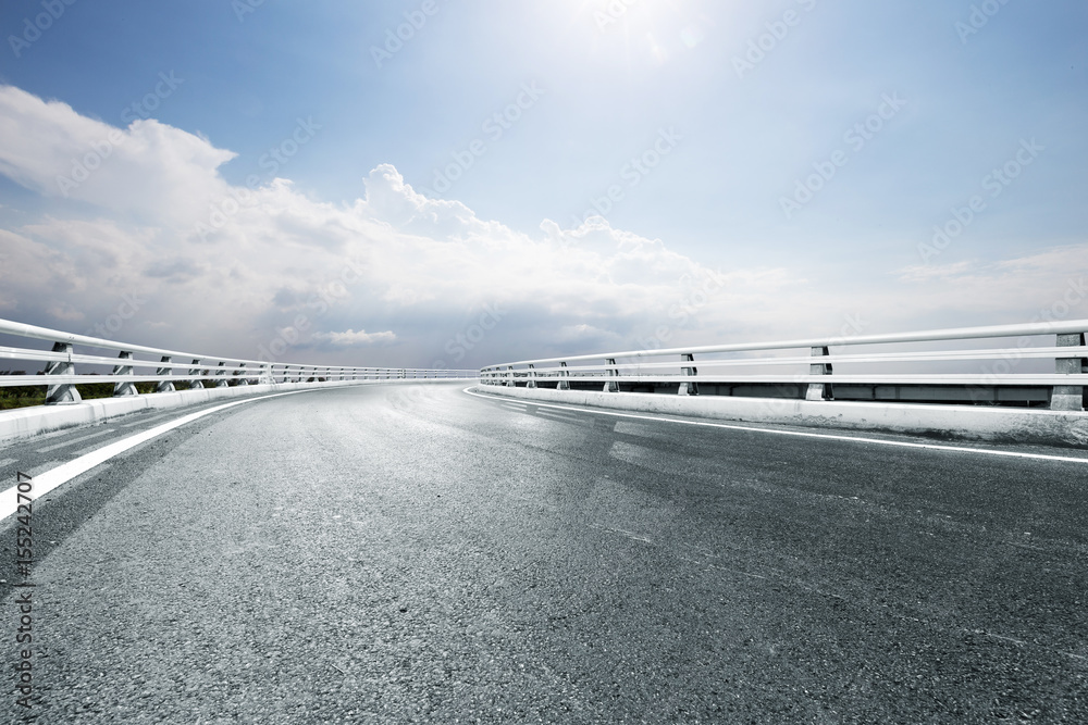 empty road in blue sunny sky