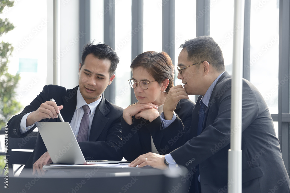 Group of business people discussing and working together during a meeting at outdoor cafe