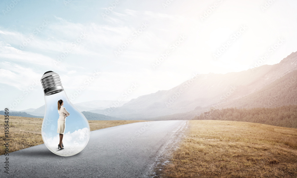 Businesswoman inside light bulb