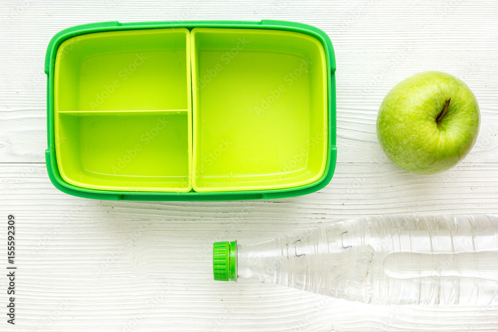 school lunch set with bottle of water and lunchbox background top view mock up