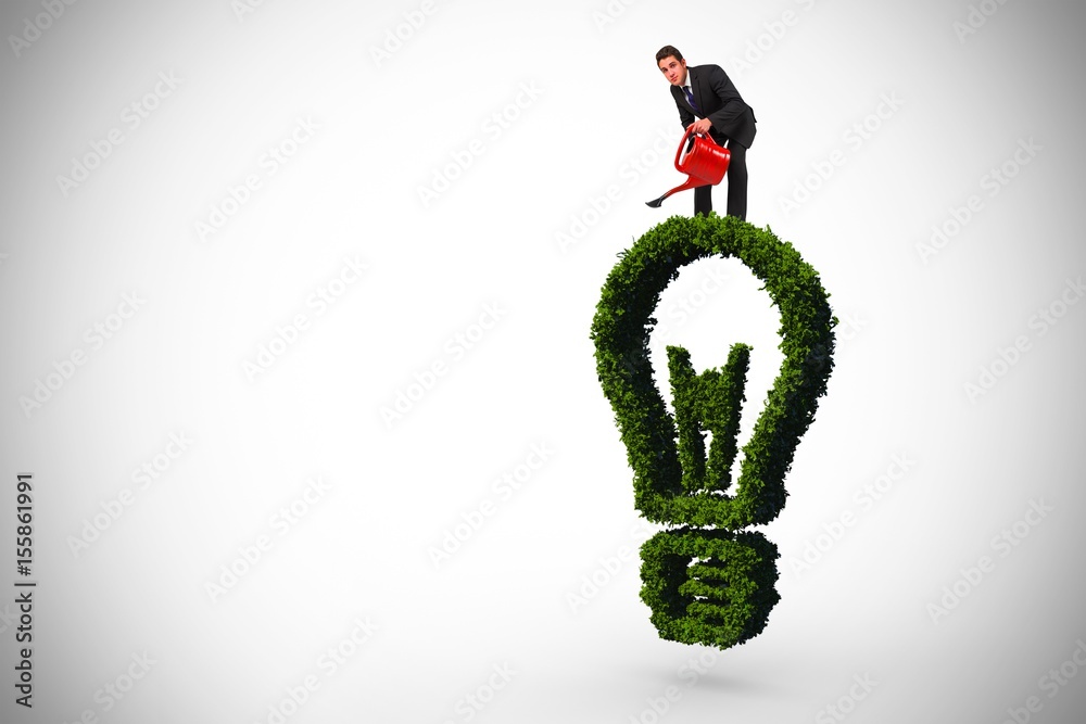 Composite image of businessman watering with red can