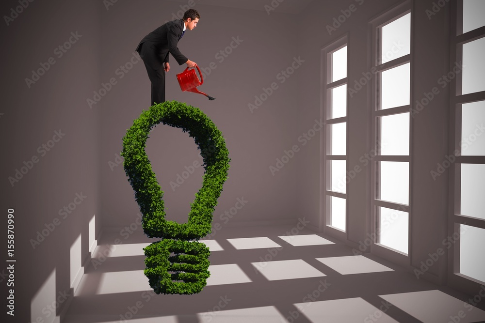 Composite image of businessman watering with red can