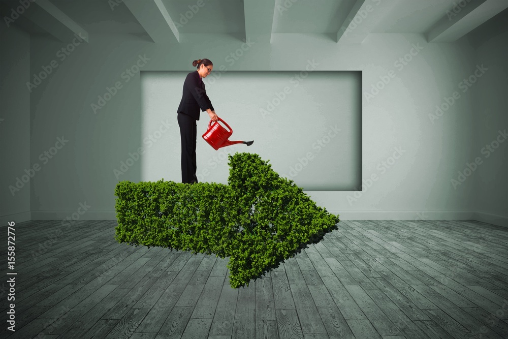 Composite image of businesswoman using red watering can