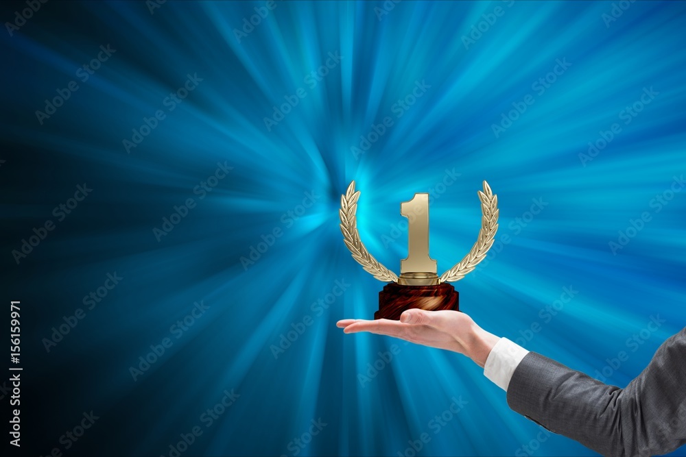 Hands of businessman holding a trophy in a blue background