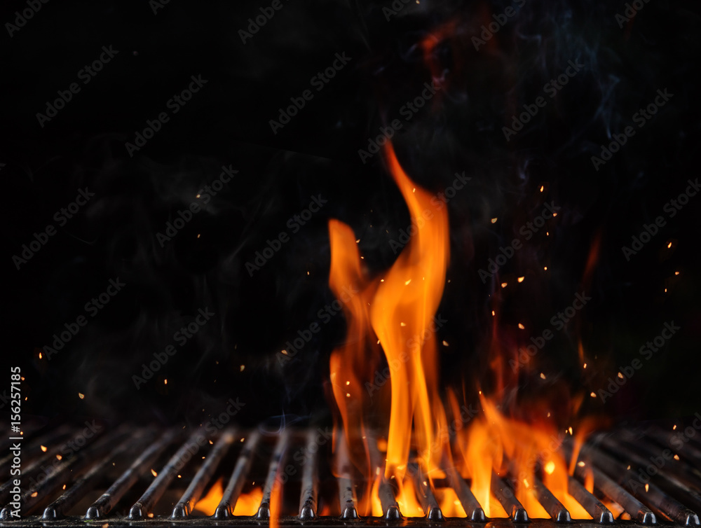 Empty flaming charcoal grill with open fire