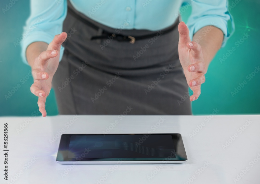 Businesswoman with open hands over tablet on desk