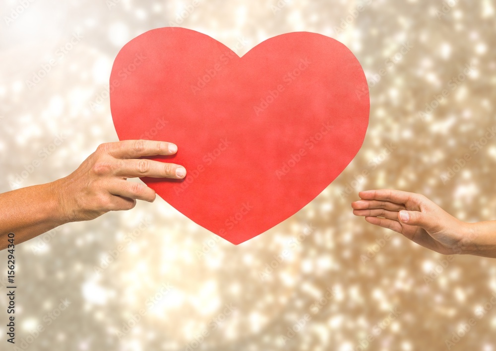 Hands holding heart with sparkling light bokeh background