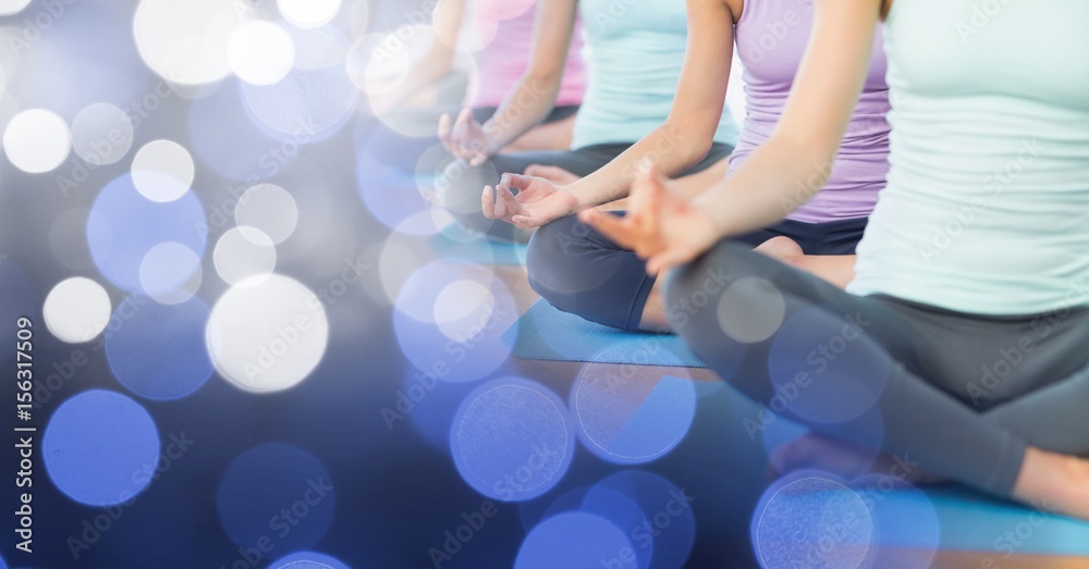 Women mid sections meditating and blue bokeh transition