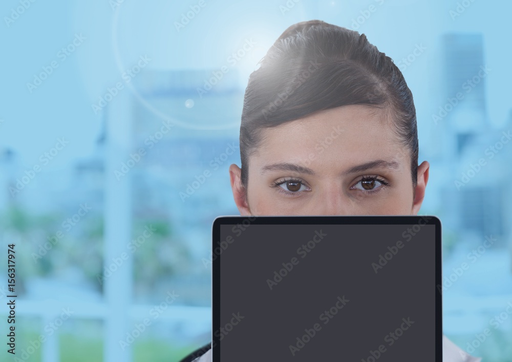 Businesswoman holding tablet in bright blue office