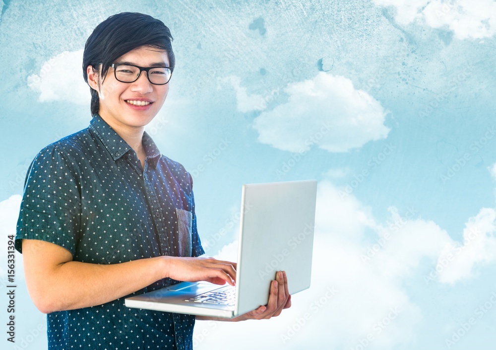 Trendy man with laptop against sky