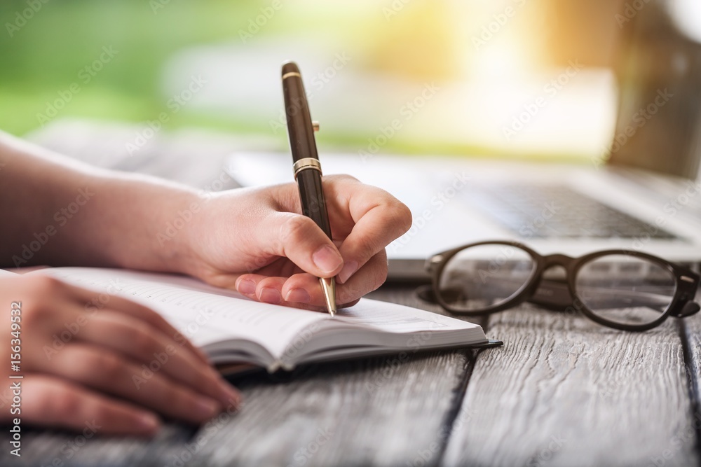 Woman writing make note.