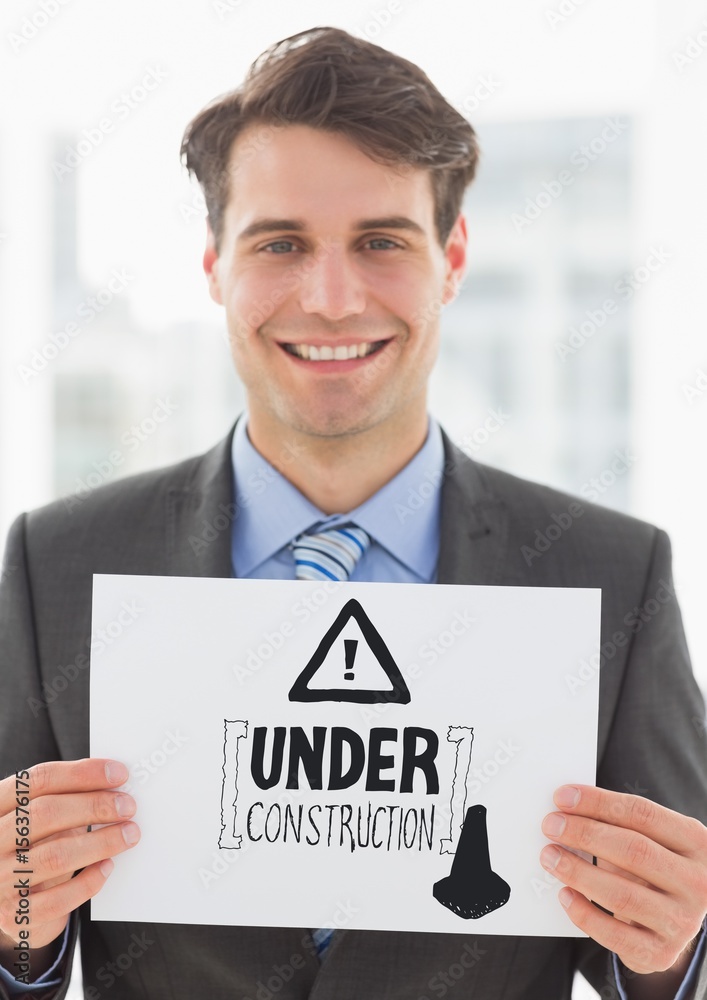 grey construction doodle on card held by business man smiling