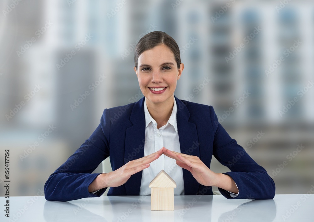 House under womans protective hands in city