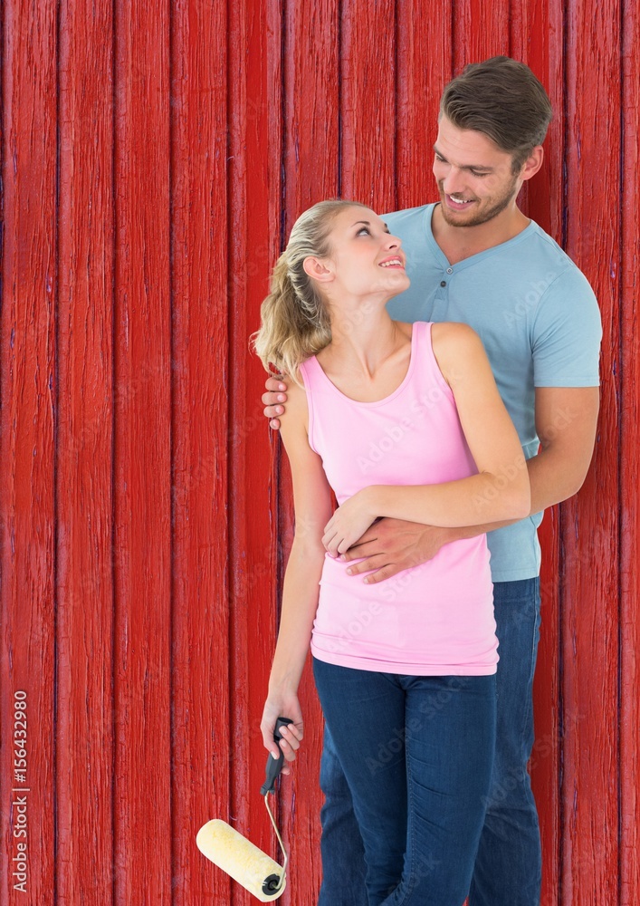 couple painting the red wood house