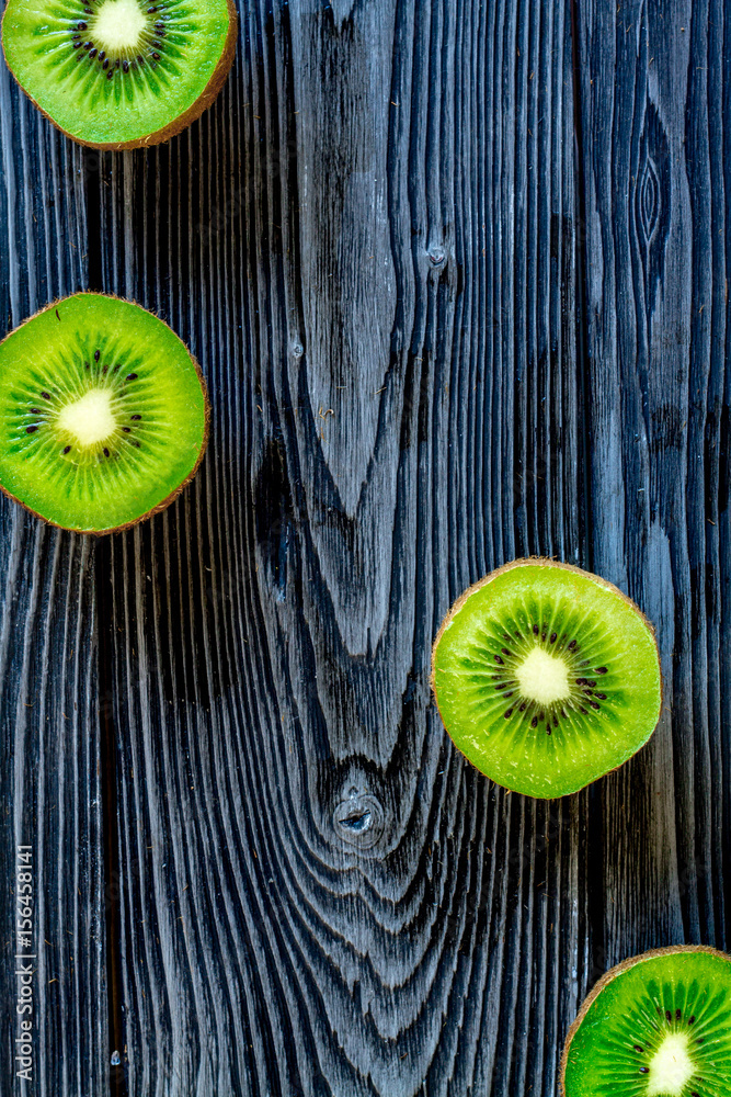 exotic fruit design with kiwi on dark wooden background top view mock up