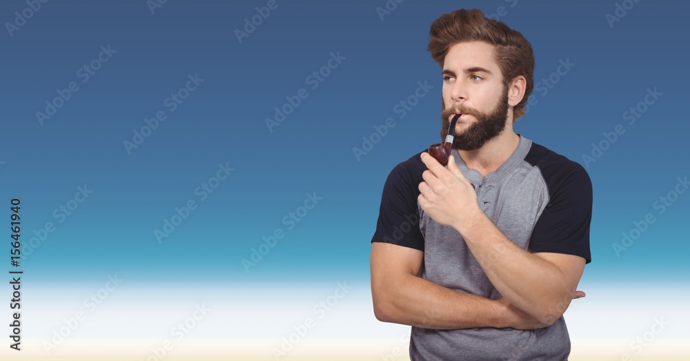 Hipster smoking pipe against blue background