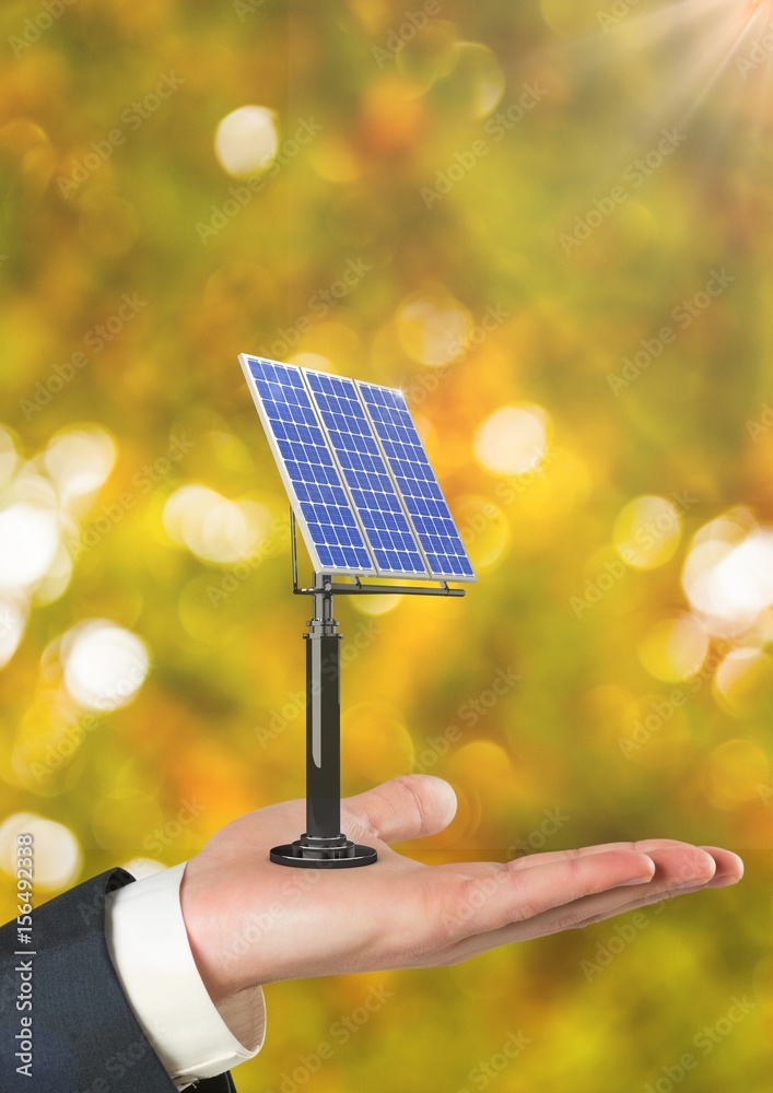 Cropped hand holding solar panel against defocused background