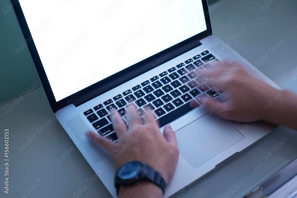 Hand typing on the laptop keyboard quickly ,motion blur effect.