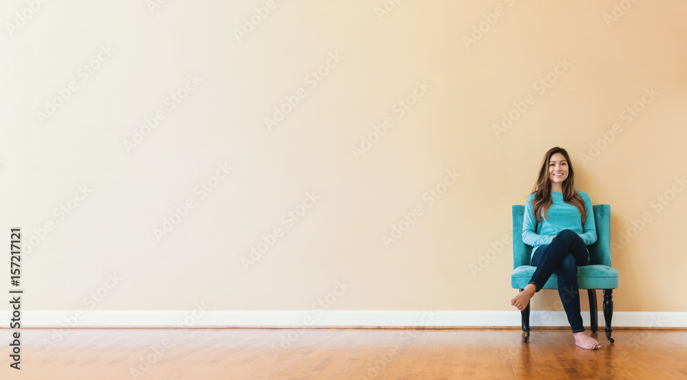 Young latina woman sitting in a chair