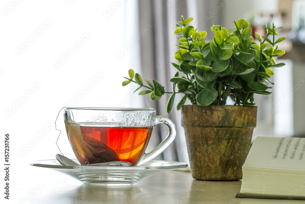 Close up the warm black tea cup on the wooden table in living room , relax with tea time concept