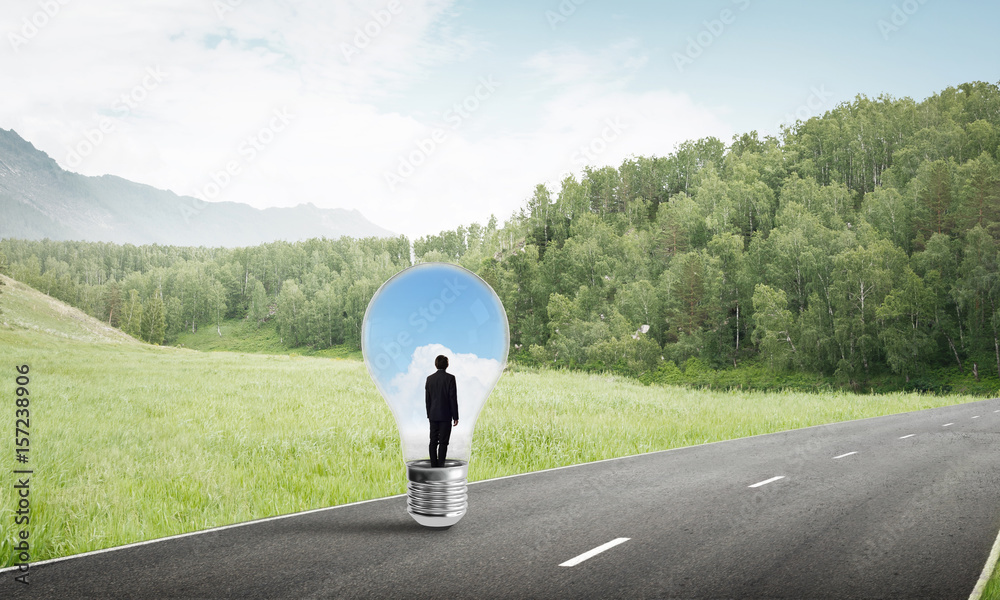 Businessman inside light bulb