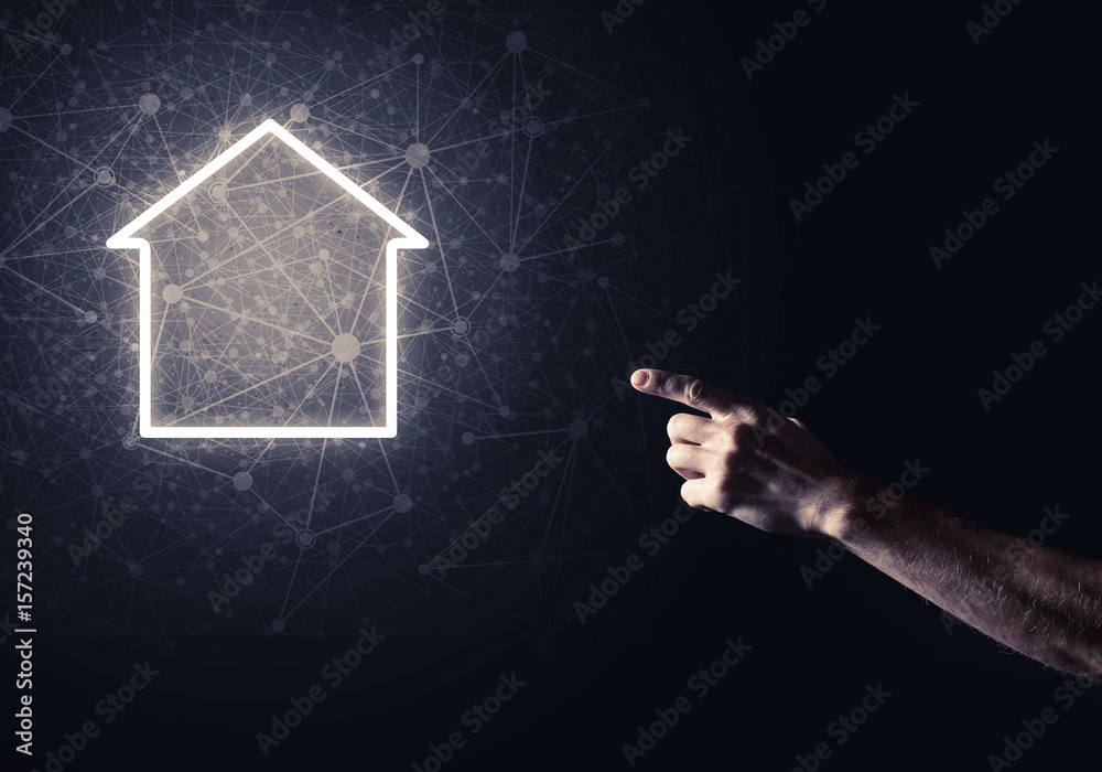 Conceptual image with hand pointing at house or main page icon o