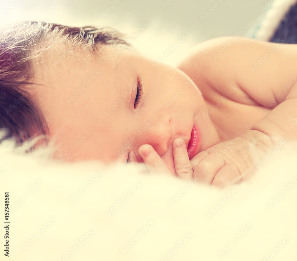 Little baby boy sleeping on fluffy blanket