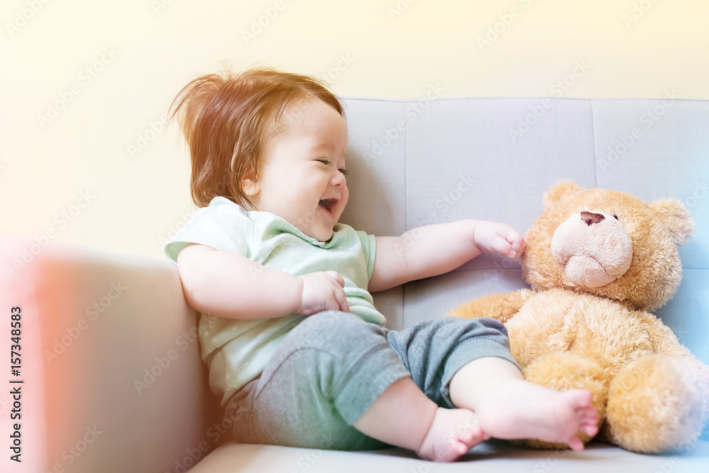 Happy baby boy with his teddy bear