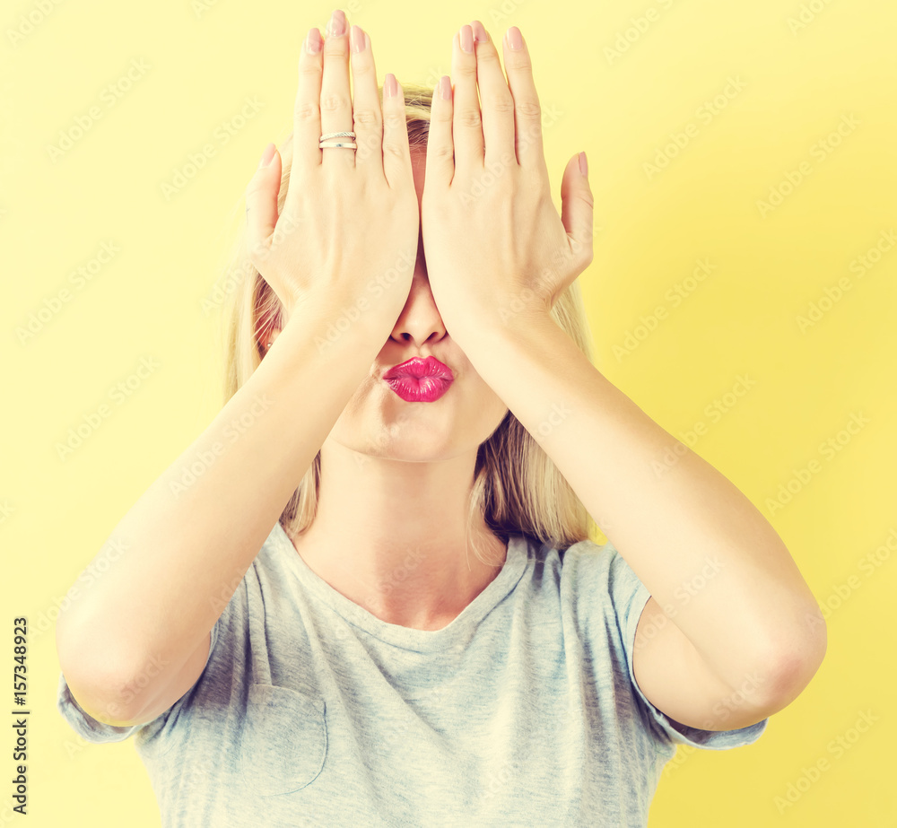 Woman covering her eyes with her hands