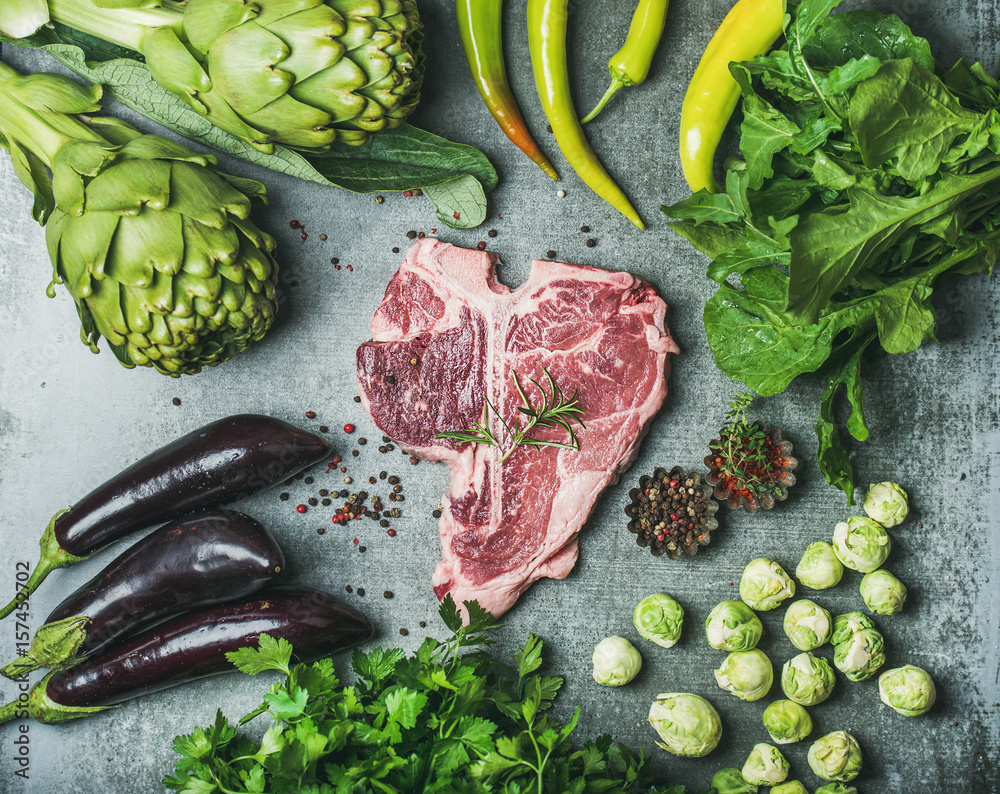 Ingredients for healthy protein rich meat dinner. Fresh raw beef uncooked t-bone steak with green ve