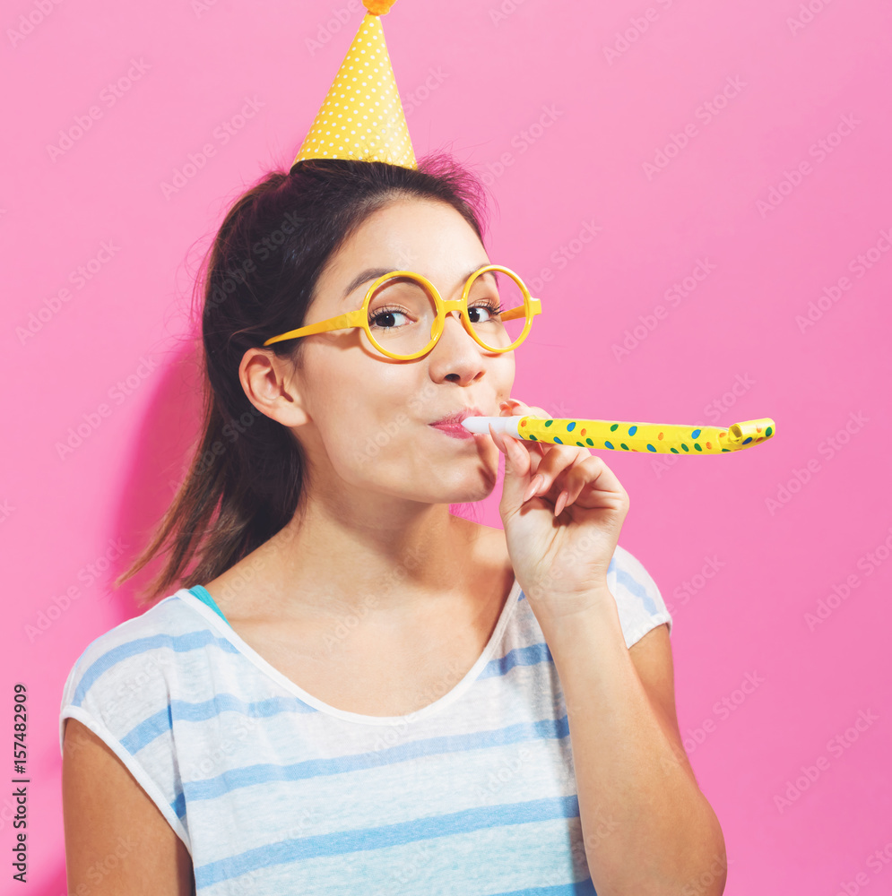 Young woman with noisemaker