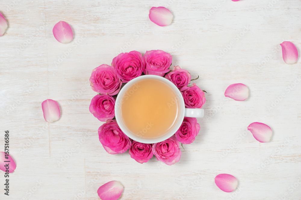 Tea time. Light background with flowers and cup of tea.